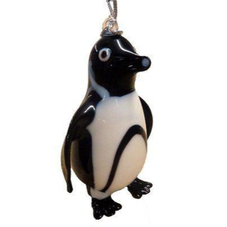 Black and white penguin shaped Christmas ornament with silver cord.