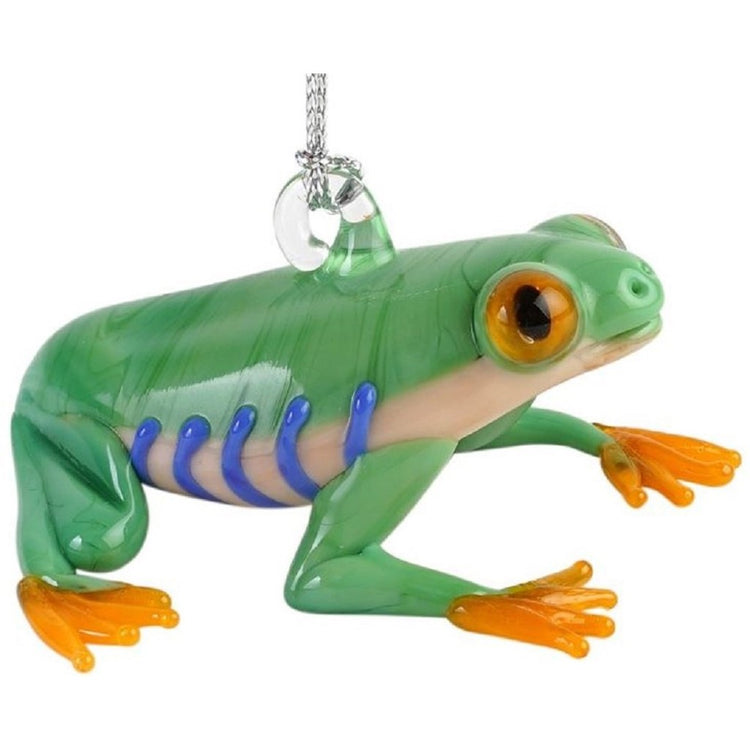 Glass frog ornament. Sitting on hind legs looking up. Light green skin with yellow feet, white belly with blue stripes
