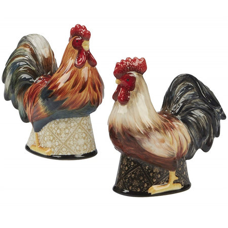 2 rooster shaped shakers one brown with darker tail feathers, 2nd white with dark tail feathers. Both have a bright red crest