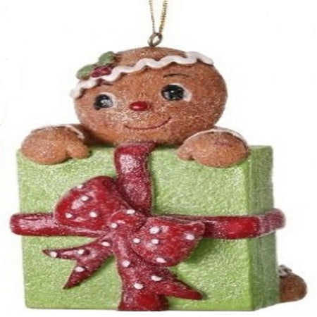 Gingerbread man with a green gift with a red bow on it
