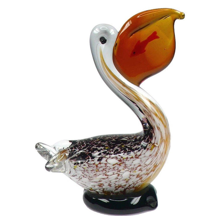 sitting glass pelican with brown, gold & white feather body. A small fish can be seen inside the orange beak.