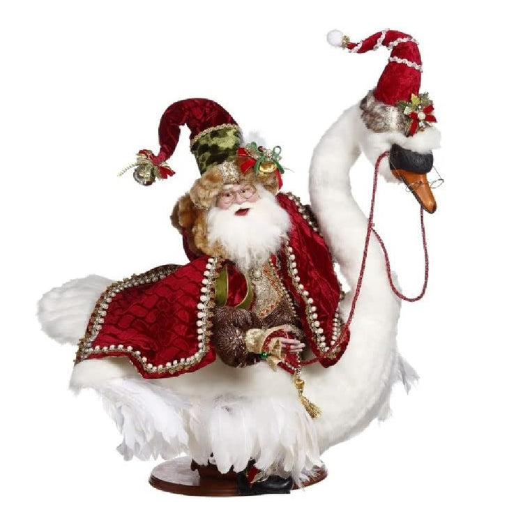 Santa wearing a red stocking cap and cloak, riding atop a white goose, also wearing a red stocking cap.