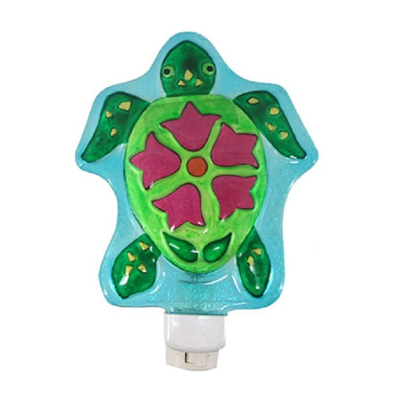 Blown glass turtle shaped night light, turtle is green with pink flower on shell.