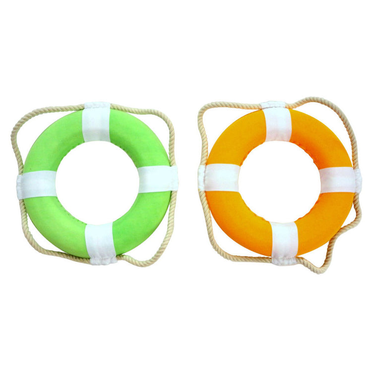 2 life preserver rings, 1 is orange & white, the other is green & white. The rope is a cream color.