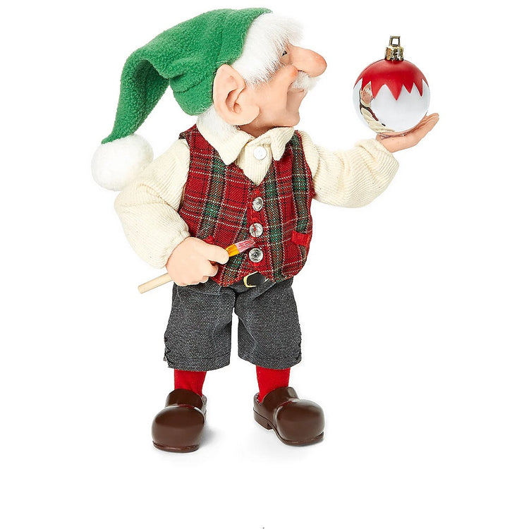 Jean Claude elf man holding an ornament. 