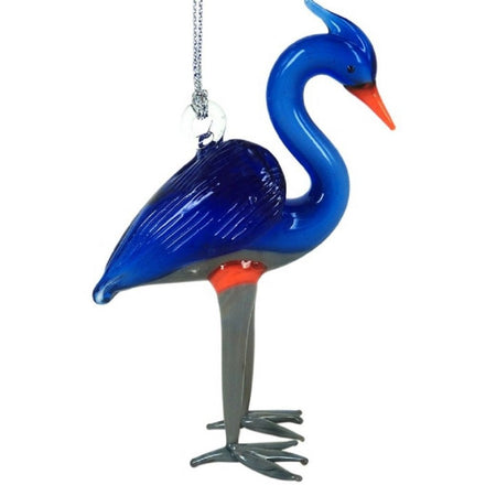 Standing blue glass heron with orange beak and ring around top of legs. Legs & feet are grey in color.