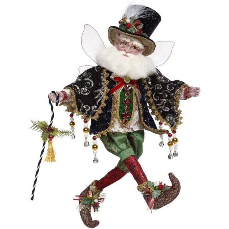 Christmas fairy with white beard and glasses. Wearing top hat adorned with holly and a feather. holding black and white cane. has black jacket with white, green and red shirt. Green shorts and red stockings.