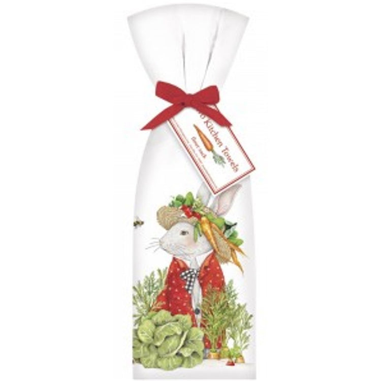 2 white towels tied with red ribbon. Towel shows a white bunny in a red jacket & hat. Around him are garden vegetables.