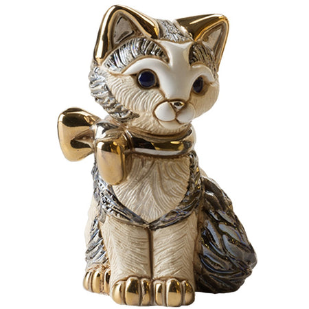 Kitten shaped figurine gazing forward.  Bold with black accent wearing a gold bow.  Lots of texture.