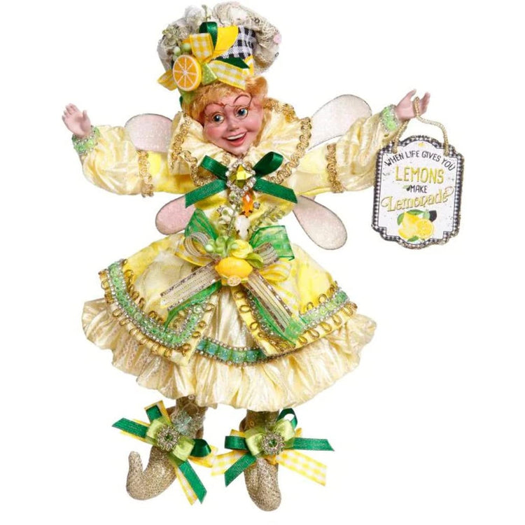 Fairy girl wearing glasses and a yellow frilly dress. The dress is yellow with green accents and bows. She carries a sign that reads "When life give you lemons make lemonade.  She sports a check hat with a lemon slice accent on hats bow.