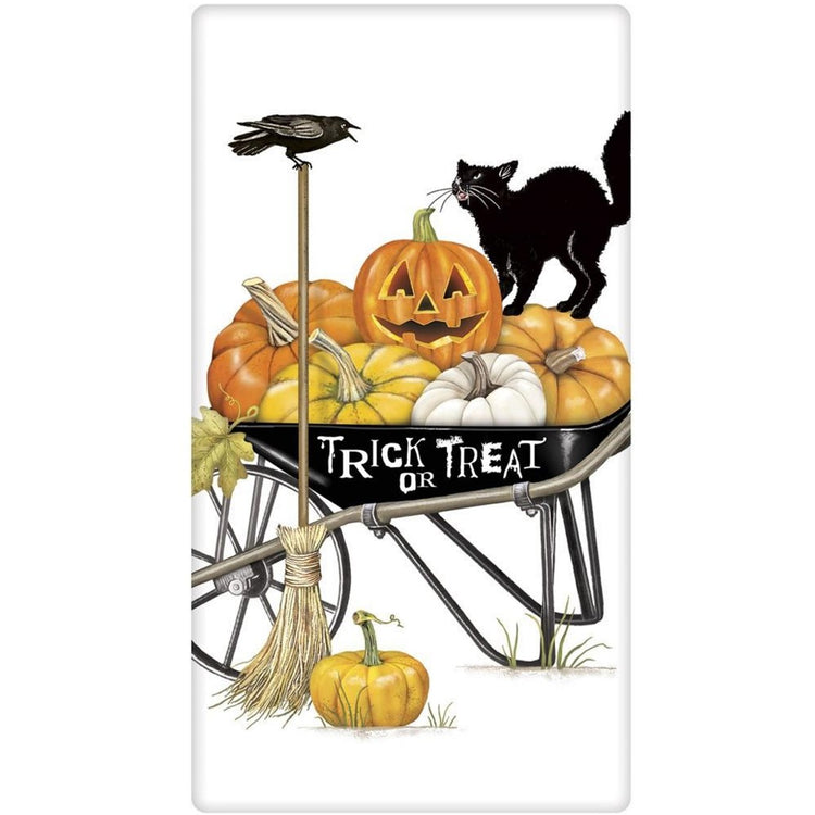 white towel with black wheelbarrow full of pumpkins, and a black cat.