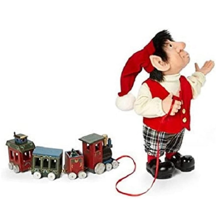 moochie the elf figurine with a toy train on a ribbon.