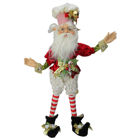 Elf figure with chef hat and red white and green outfit.