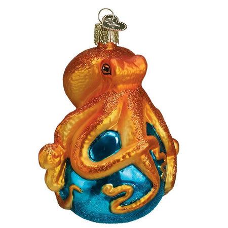 Blown glass octopus ornament. Octopus is orange and sitting on blue ball.