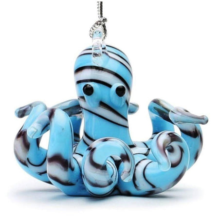 Light Blue glass octopus ornament with white black outlined stripes. Eyes on head with tentacles all curled up. Hanger on top.