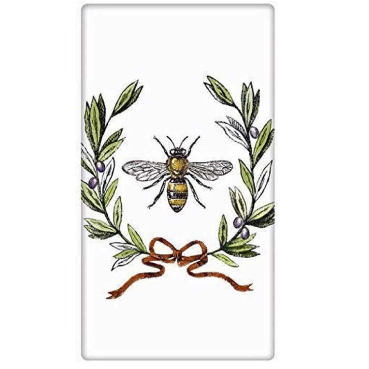 white flour sack towel with printed image of a bee surrounded by a wreath of olive branches tied with a red ribbon.