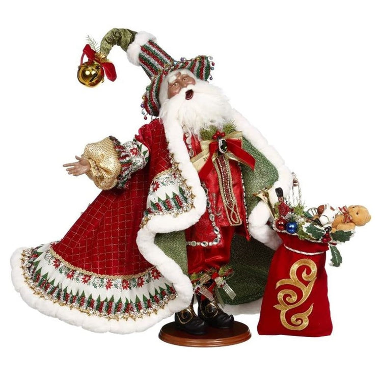 Santa figurine wearing red suit, red cloak with white fir trim, long hat in red green and silver stripes. he's holding a red sack full of toys.