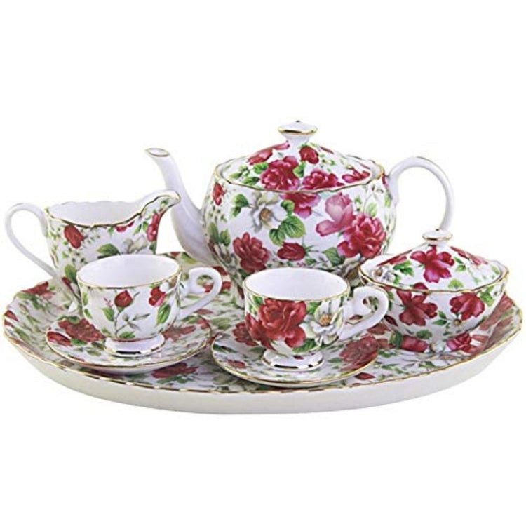 White tea set with pink, red & white florals & green leaves. 