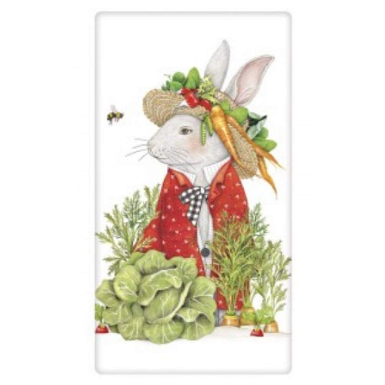 White rabbit in a hat with carrots, lettuce, and radishes. 