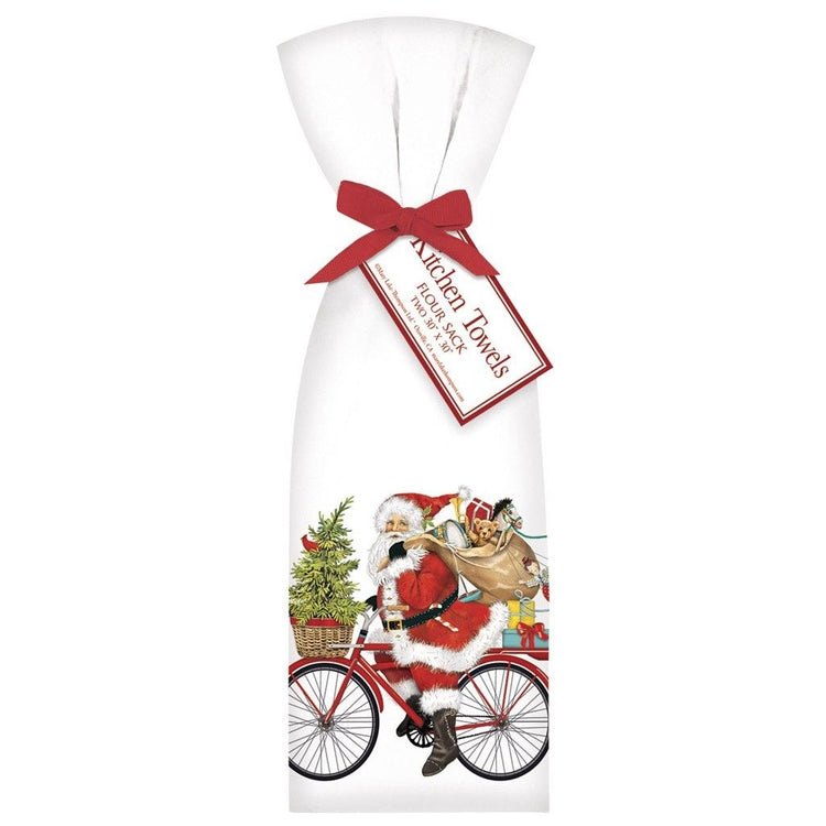 2 white towels tied with red ribbon. Towel shows Santa riding a red bike with a fir tree in the basket & a sack of toys.