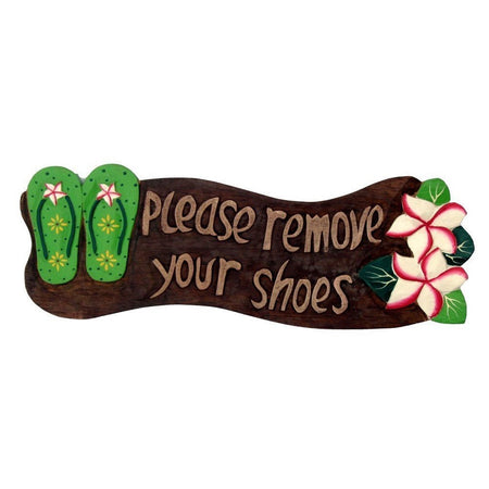 Brown wood sign with green flip flops & pink & white hibiscus. Saying 'please remove your shoes'.