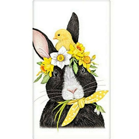 White towel with a black & white rabbit wearing a yellow polka dot banana & a flower crown with a chick on top.