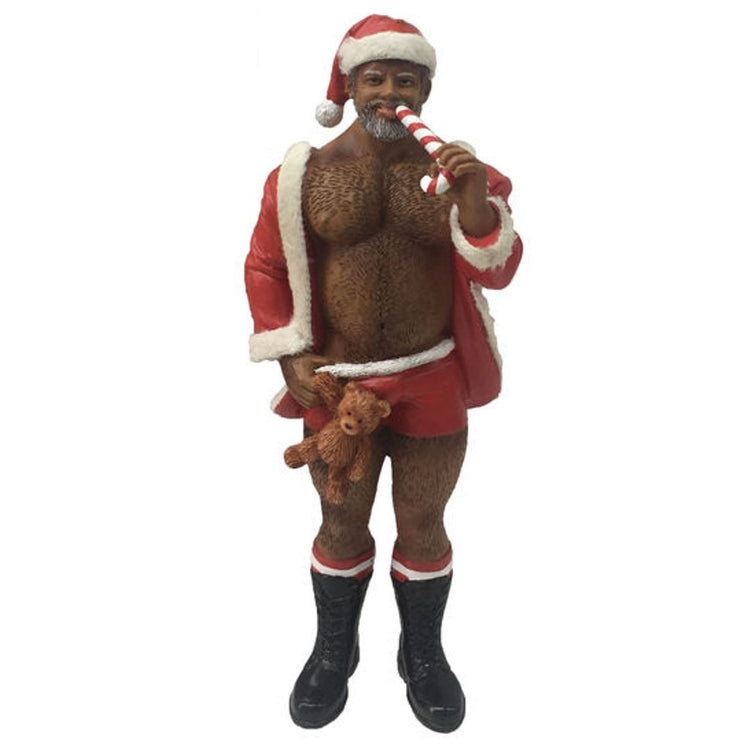 African American man dressed in a santa type suit.  Shirt is open in front, santa hat, candy cane and teddy bear.