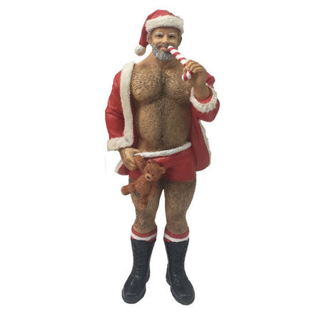 Man dressed in Santa suit hanging ornament.  He is eating a candycane.  Open jacked reveals hairy chest.