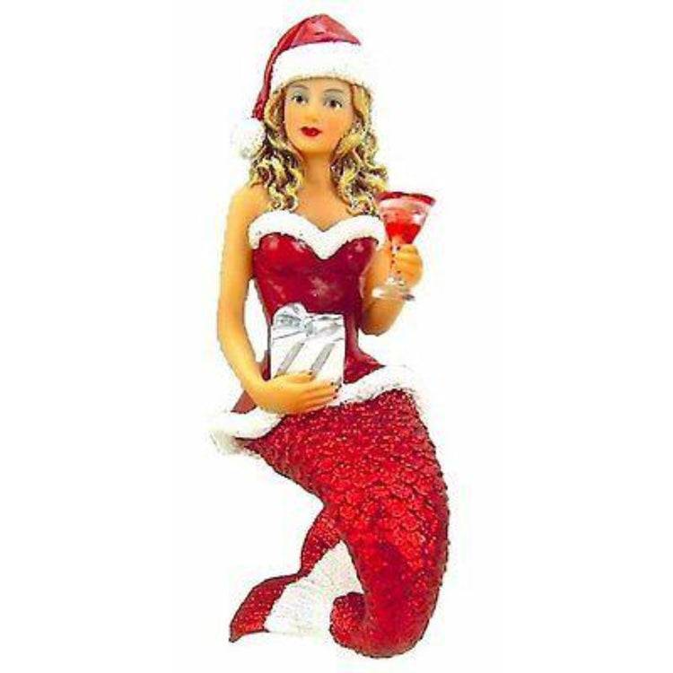 Mermaid shaped figurine hanging ornament.  Wearing a red Santa suit , holding a wrapped gift and red cocktail.