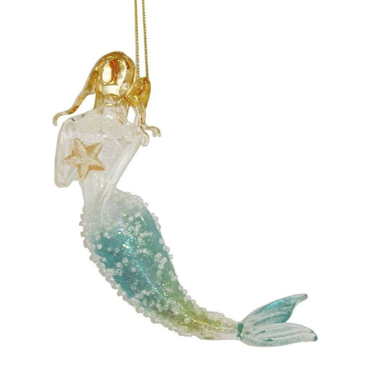 Glass mermaid with gold hair, one hand at ear, other holding a starfish. Tail is blue/green