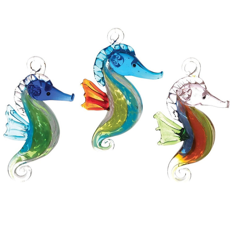 3 blown glass seahorse ornaments, with blue, green and orange colored accents.