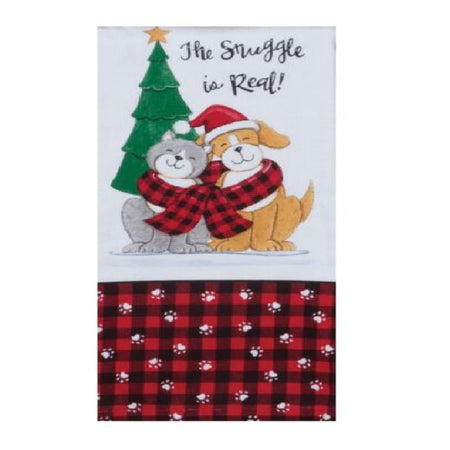 white towel with printed design of a pine tree, a grey cat and yellow puppy sharing a red and black plaid scarf. "The struggle is real!" is printed above them, and a red and black plaid border accented with white paw prints along the bottom of the towel.