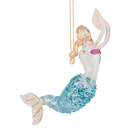 Glass mermaid swimming up while holding a shell out in front.  Hair is gold with tail teal and gold. Hanger attached to back