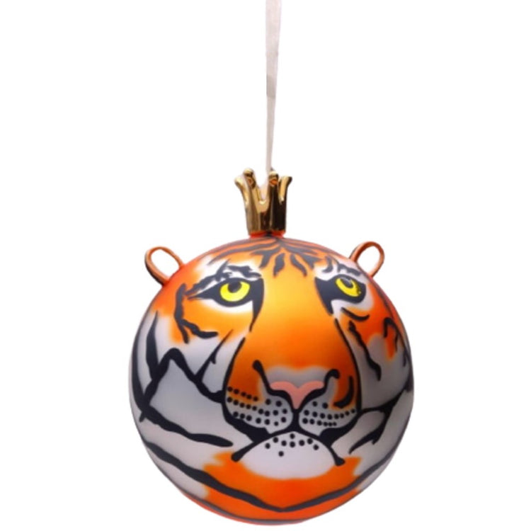 Blown glass ball ornament, had painted to look like an orange tiger, there are ears that are attached towards the top, and the ribbon is attached to a crown at the top of the tiger.