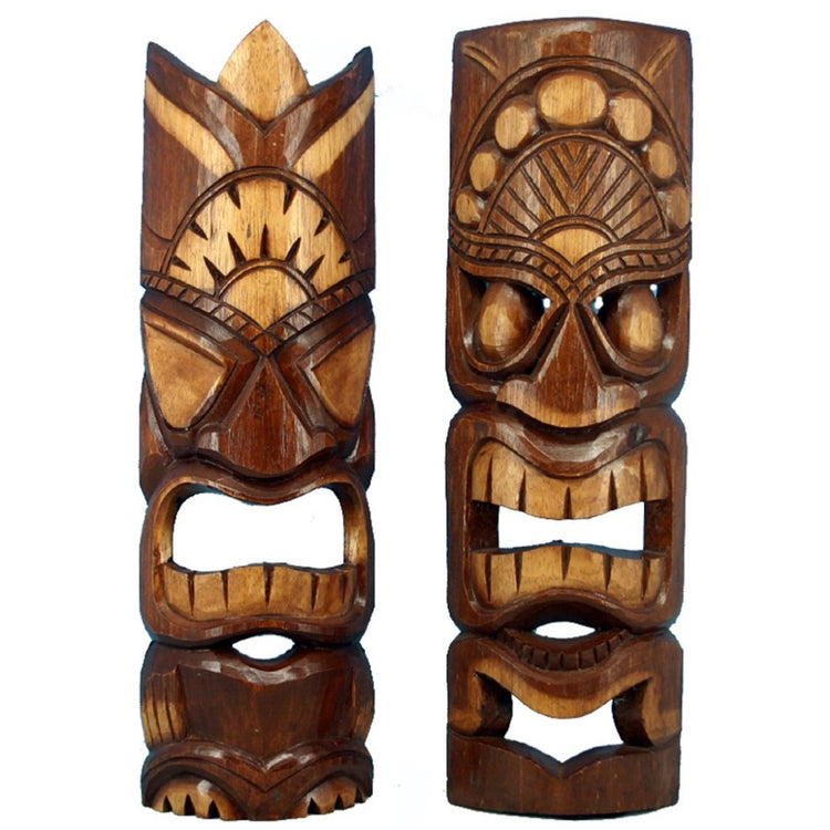2 carved dark and light brown wood tiki masks.