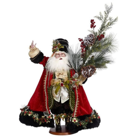 Santa wearing long red coat trimmed with black fur, matching hat and holding a fir tree with pinecones and berries.