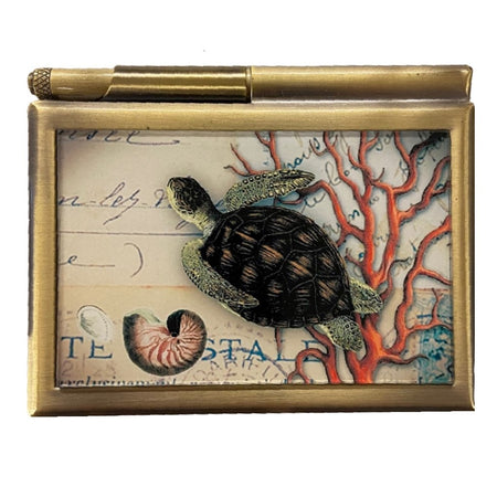 Bronze note pad case with glass picture of a sea turtle and coral.