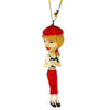 ornament shows blond girl in red beret, green top & red slacks standing & holding a white poodle