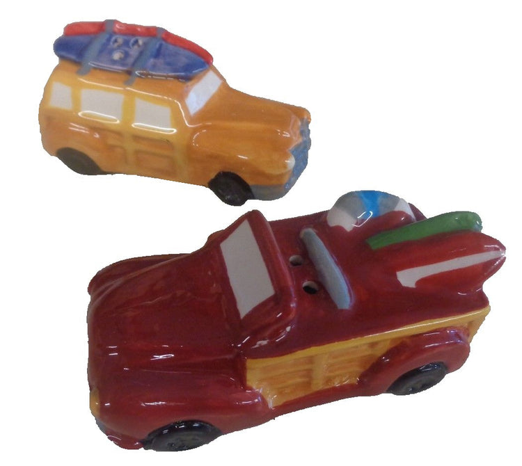 Red and yellow beach car with surfboards on top shaped salt & pepper.
