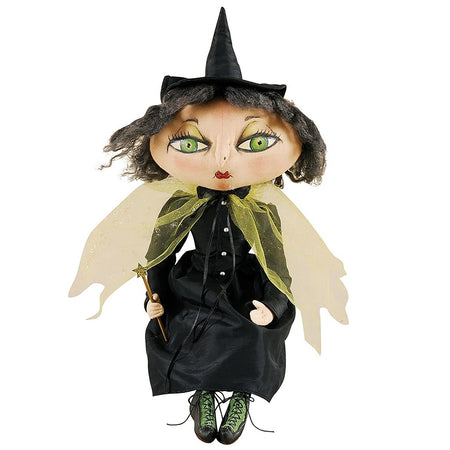 Fabric witch figurine with green eyes, cape and a magic wand.