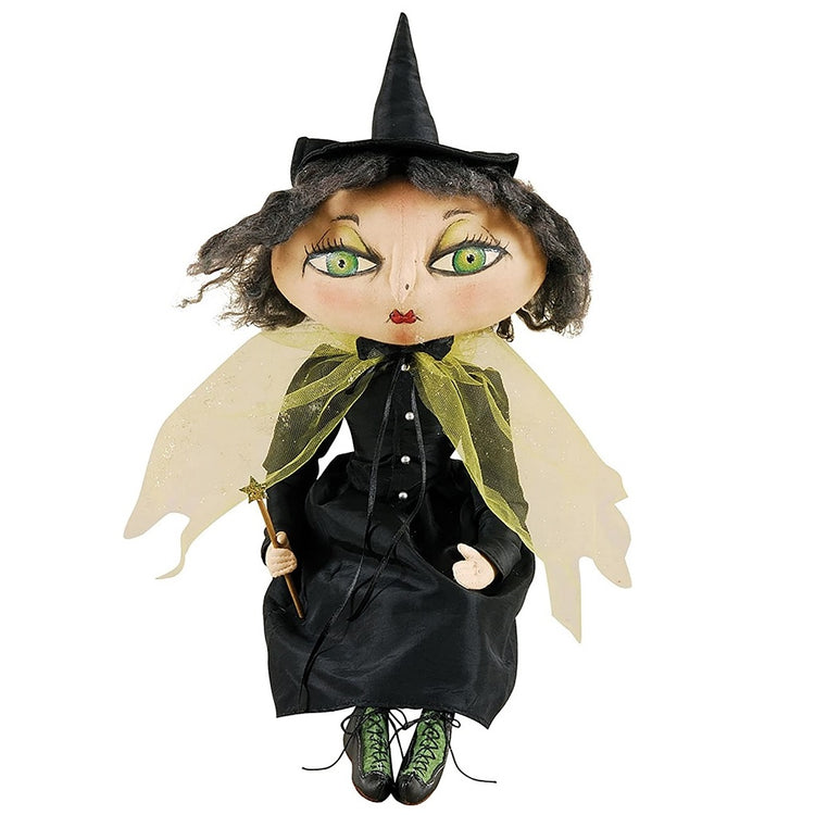 Fabric witch figurine with green eyes, cape and a magic wand.