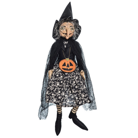 Witch with a black witch costume & a jack-o-lantern pumpkin necklace.