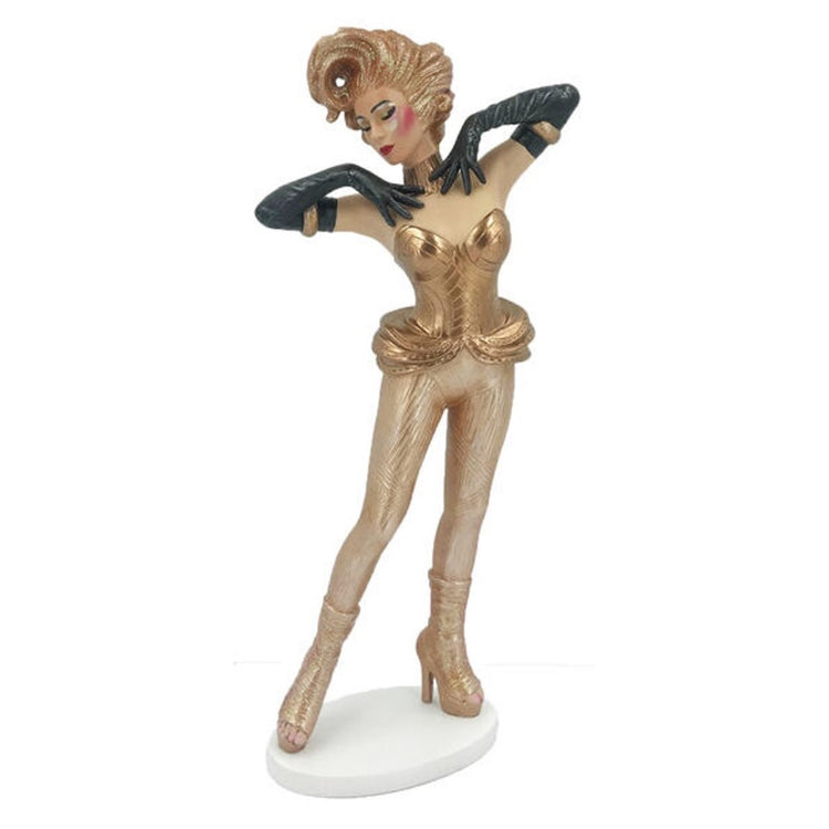 Drag queen figurine with gold hair, blouse, pants and platform shoes. Wearing long black gloves with hands on shoulders.